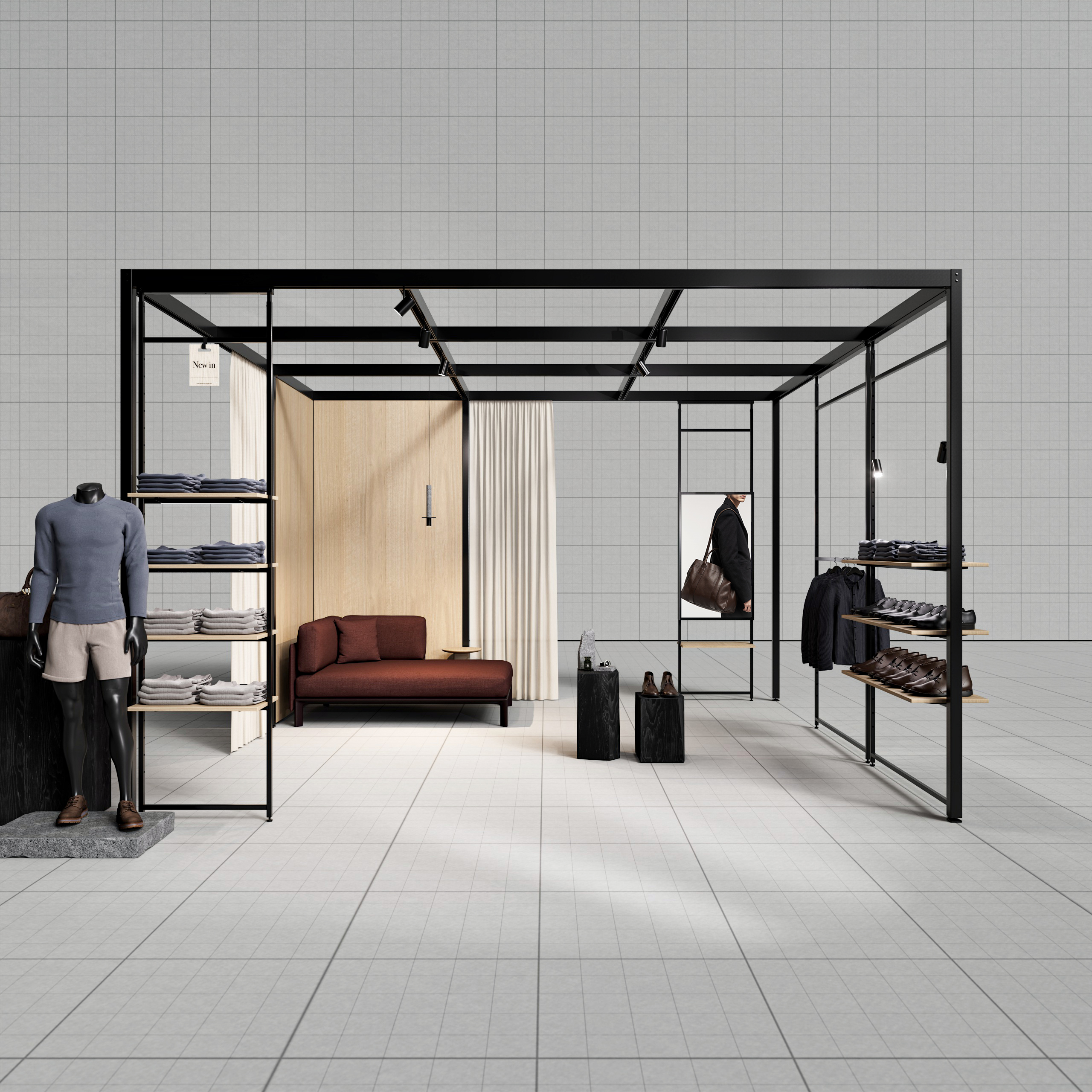 Freistehendes schwarzes Metallgestell mit Herrenmode, Schuhen, zwei Koffern und braunem Sofa vor heller Wand mit Vorhang.